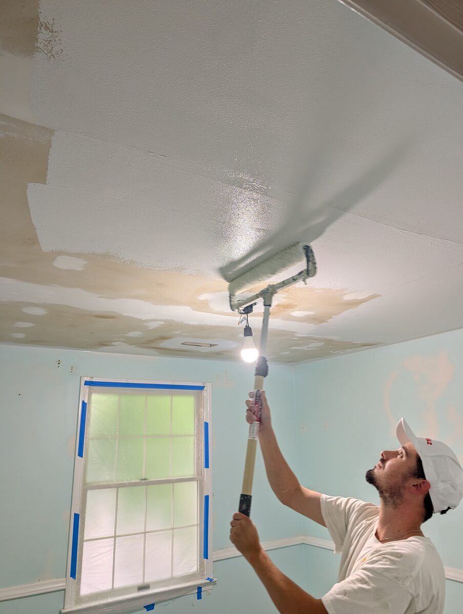 Ceiling being primed and repainted after popcorn texture removal